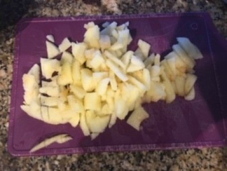 Sliced apples on a cutting mat.