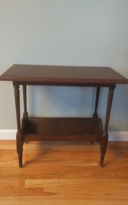 A wooden side table with a lower shelf.