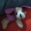 A small purple and white stuffed dog.