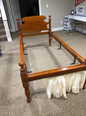 A wooden bed frame with a headboard.