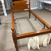 A wooden bed frame with a headboard.