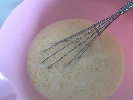 Mixing the pancake batter in a bowl.