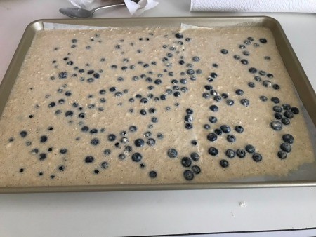 The lemon blueberry batter poured into a sheet pan.