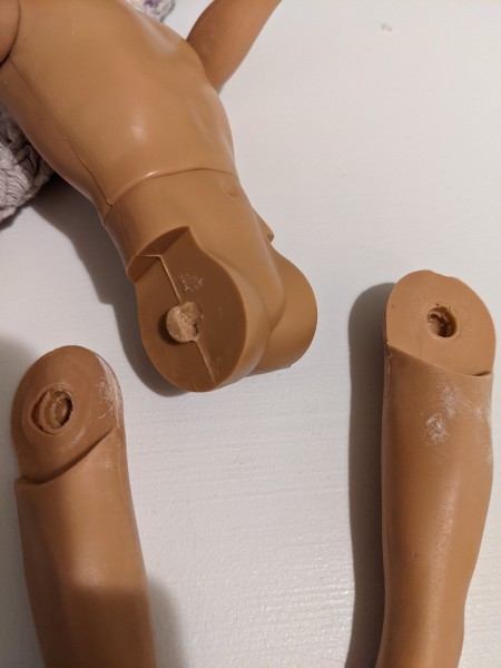A doll leg with a broken pin.