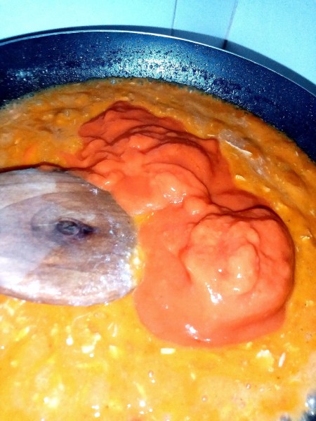 Adding ingredients to the pan.