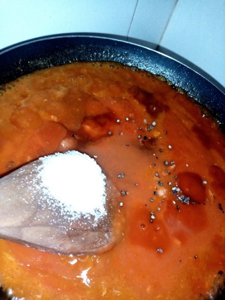 Adding ingredients in a pan.