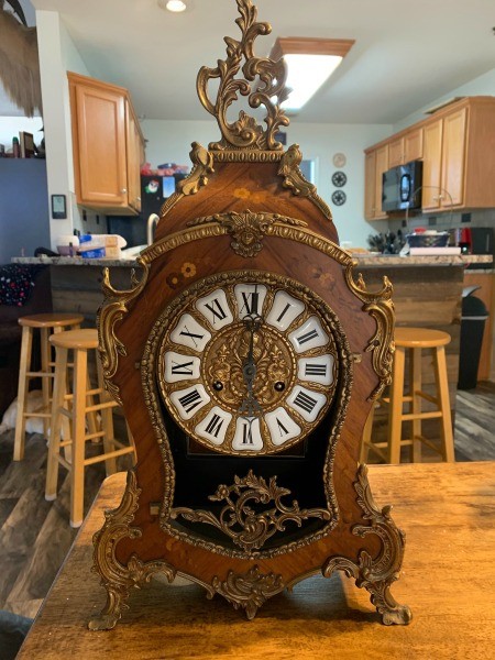 An antique wooden mantle clock.