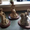 Three figurines of fancy ladies.