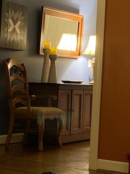 A wooden sideboard in a living room.