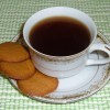 Ginger snaps next to a cup of coffee.