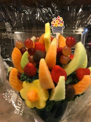 A fruit arrangement with kale as a spacer.