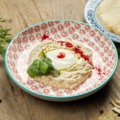 A plate of baba ganoush with pita bread.