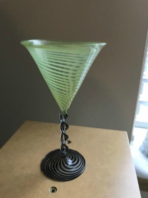 An ornate green cocktail glass.