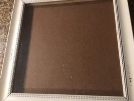 The empty wooden frame.