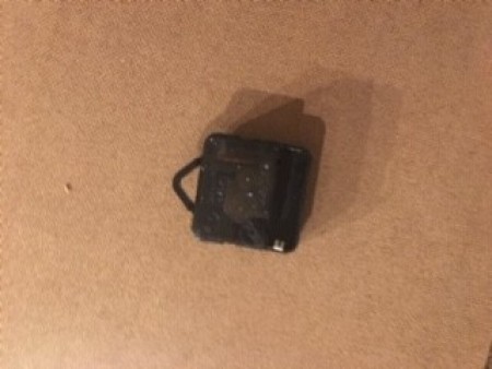 The clock movement on the back of the frame.