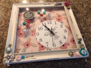 A decorative clock in a frame.
