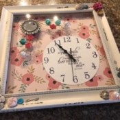 A decorative clock in a frame.