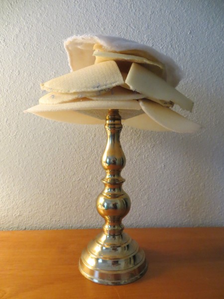 Foam pieces on top of a brass candlestick.