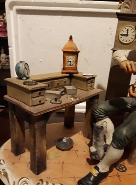 A figurine of a clock maker.