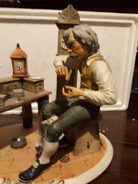 A figurine of a clock maker.