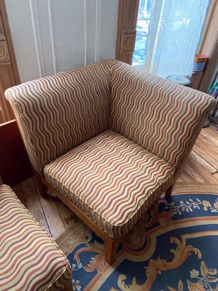 A corner stuffed easy chair.