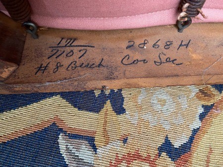 The markings on the bottom of a chair.