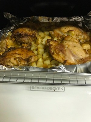 A sheet of roasted rosemary chicken with potatoes.