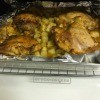 A sheet of roasted rosemary chicken with potatoes.