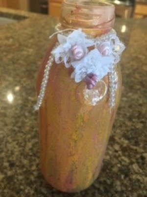 A painted bottle with embellishments.