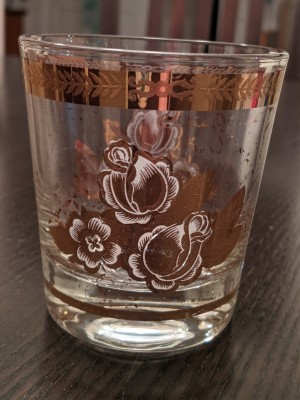 An ornate drinking glass with gold decorations.