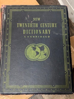 A hardbound dictionary with a black cover.