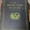 A hardbound dictionary with a black cover.