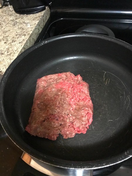 Cooking ground beef in a frying pan.