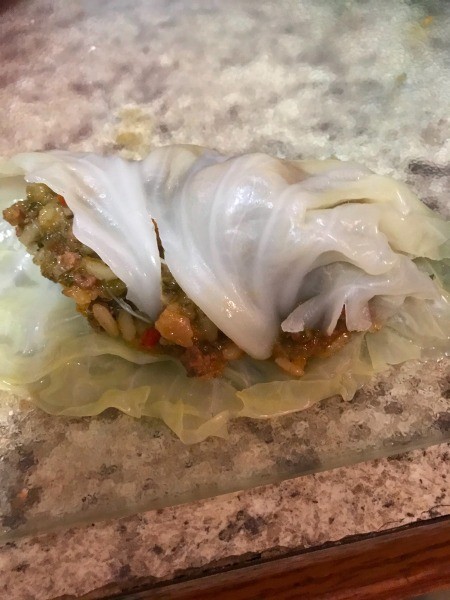 Filling the leaves with the stuffing mixture.