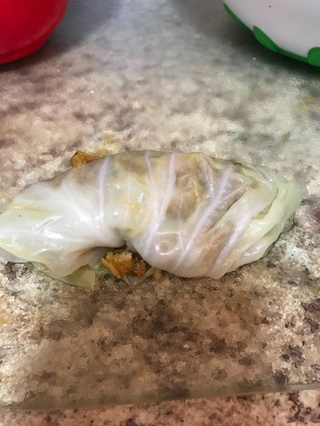 Filling the leaves with the stuffing mixture.