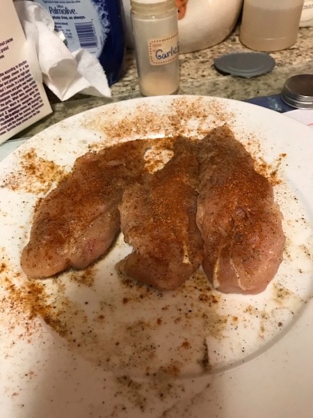 Chicken breasts pounded flat with seasoning.