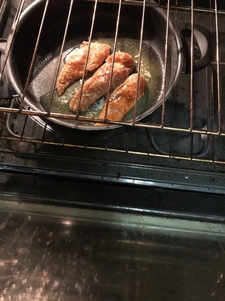 Cooking the chicken breast in an oven.