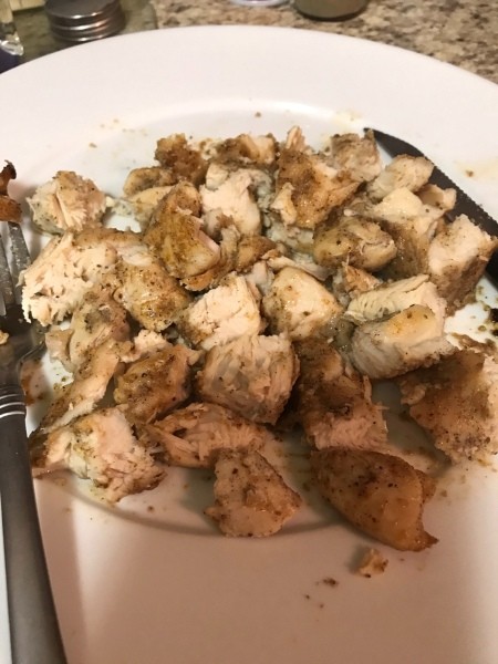Cooked chicken pieces on a plate.