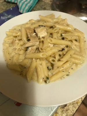 A plate of lemon cream basil pasta with chicken.