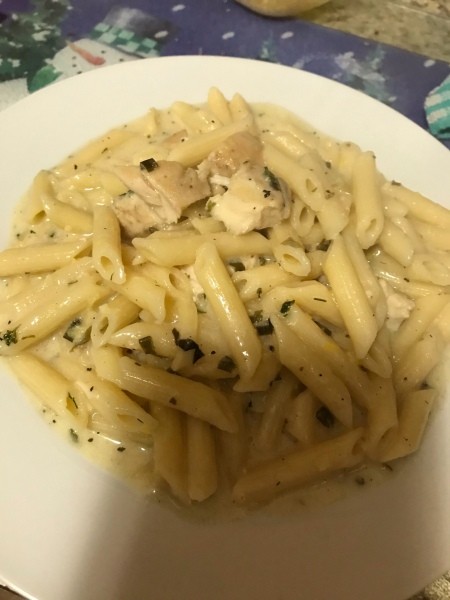 A plate of lemon cream basil pasta with chicken.