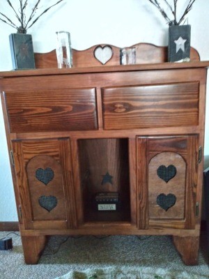 A wooden piece of furniture with heart decorations.