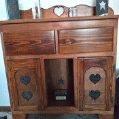 A wooden piece of furniture with heart decorations.