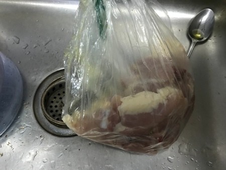 Chicken thighs in a plastic bag.