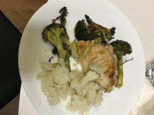 A plate of chicken and broccoli with mashed potatoes.