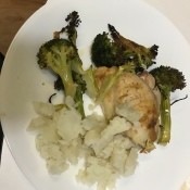 A plate of chicken and broccoli with mashed potatoes.