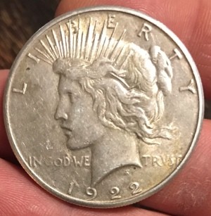 The front of an old dollar coin.