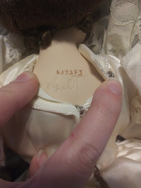 The numbers on the back of a doll's neck.