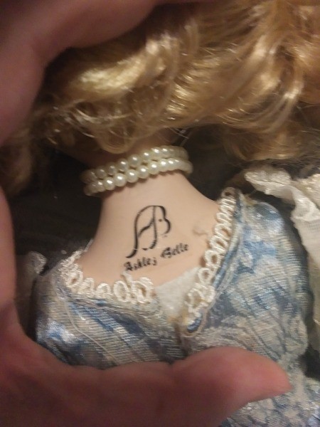 The marking on the back of a porcelain doll.