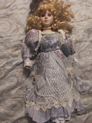 A porcelain doll in an ornate dress.