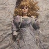 A porcelain doll in an ornate dress.